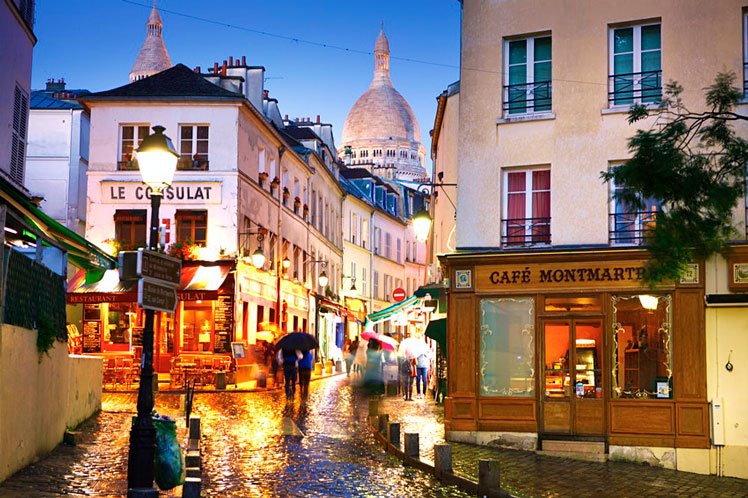 Dome of Sacre Coeur de Montmartre seen above cobbled street at night © Matt Munro / Lonely Planet